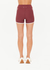 THE UPSIDE women’s red recycled peached Samara 3.5inch Spin Short offers a soft & supportive fit and features side pockets and contrast cream stripes. Made for pilates.