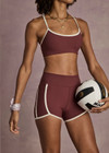THE UPSIDE women’s red recycled peached Samara 3.5inch Spin Short offers a soft & supportive fit and features side pockets and contrast cream stripes. Made for pilates.