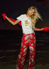 THE UPSIDE women's red Palma Sierra Wide Leg Pant features cream contrast panels, turquoise piping, soft elastic waistband, and side pockets. Perfect for travel or lifestyle.