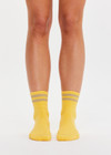 THE UPSIDE women’s yellow Curio Crew Sock with jaquard stripes in gold metallic yarn.