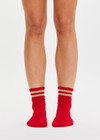 THE UPSIDE women’s red Curio Crew Sock with jacquard stripes in gold metallic yarn.