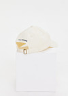 THE UPSIDE women’s cream Good Luck Soft Cap features an embroided 'Good Luck' on front with an adjustable strap at the back.