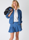 THE UPSIDE women’s blue denim Lykke Jaida Pleated Skirt, in a soft chambray fabrication, features an inner spin short with piping at the top edge. Made for tennis.