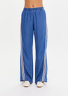 THE UPSIDE women’s blue Lykke Juliet Pant in soft chambray features a low-rise fit, split hem, and contrasting mesh knit side stripe. The perfect travel pant.