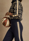 THE UPSIDE women’s navy organic cotton Cosmo Kairo Half Zip Knit is a relaxed fit and features a half zip front and beige knitted stripes down sleeves. Made for everyday leisure.