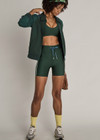 THE UPSIDE women’s green eco tech Maneki 5In Spin Short offers a supportive, comfortable fit with elastic drawcord waist and quick-dry breathable fabric. Made for lifestyle.