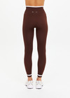THE UPSIDE women's brown Form Seamless 25in Midi Pant is designed for a firm & supportive fit and features contrast white stripes on waist and ankles. Made for yoga & pilates.