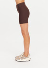 THE UPSIDE women's brown high-waisted Peached 5inch Spin Short offers a soft & supportive fit in recycled peached fabric and features a printed arrow logo on back waistband. Made for pilates & yoga.