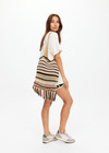 THE UPSIDE women's stripe Bohemia Kelly Crochet Bag is an organic hand-crochet tote with knotted tassel details and wooden beads. Made for lifestyle.