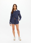 THE UPSIDE women's navy & white stripe Belize Bobbi Collared Shirt features a ruffled detail and sleeve cuff with button closure in linen fabrication. Made for lifestyle.