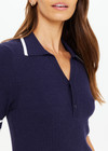 THE UPSIDE women's navy tennis Plume Knit Collared Dress fits true-to-size and features a drop waist with gathered skirt and a drawcord with tennis charms.