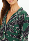 THE UPSIDE women's floral Tamara Rio Collared Shirt is a true-to-size fit featuring a green palm print, pearlised shell buttons and contrast cream piping. Made for lifestyle.