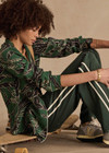THE UPSIDE women's floral Tamara Rio Collared Shirt is a true-to-size fit featuring a green palm print, pearlised shell buttons and contrast cream piping. Made for lifestyle.