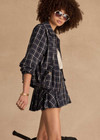 THE UPSIDE women's check Valencia Jones Pleated Skirt is true to size with structured waistband, belt loops, and antique brass button closure at centre front. Made for lifestyle.