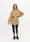 THE UPSIDE women's brown Rylan Anorak is relaxed fit, mid-length, made from tan wrinkled water-resistant fabric. Made for yoga & pilates.