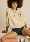 THE UPSIDE women's natural Molokai Paloma Crew is boxy fit with an embroidered green palm tree logo at front chest. Made for lifestyle.