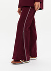 THE UPSIDE women's maroon Mendoza Jackie Flare Pant is true to size and features cream piping along side seams and zipper pockets. Made for lifestyle.