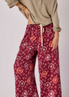 THE UPSIDE women's maroon Miri Kato silk wide-leg pant is designed for an oversized fit and features a gathered front waist with cream plaited drawcord. Made for lifestyle.
