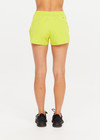 THE UPSIDE women's green recycled polyester Lucky Run Short is designed for a true-to-size fit and features a slightly curved hem with inner short for full coverage. Made for running.