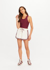 THE UPSIDE women's cream Klio Short is designed for a mid-rise, relaxed fit and features a soft elasticated waistband with drawcord and contrast binds in maroon along curved hem. Made for everyday.