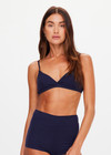 THE UPSIDE women's navy Palais Rib Capri Bra is designed to be worn under sheer garments and features a v neckline with adjustable straps in a soft ribbed fabrication. Made for lifestyle.