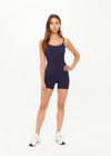 THE UPSIDE women's navy Form Seamless Jamie Bodysuit is firm and suportive and features a scooped neckline with a double layer bra with contrast tan underlayer. Made for pilates and yoga.