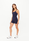 THE UPSIDE women's navy Form Seamless Jamie Bodysuit is firm and suportive and features a scooped neckline with a double layer bra with contrast tan underlayer. Made for pilates and yoga.