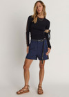 THE UPSIDE women's navy Toledo Leon Bermuda Short is a longerline tailored short featuring tan knitted tape down sides, flat waistband with belt loops and side pockets. Made for lifestyle.