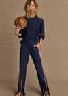 THE UPSIDE women's navy Toledo Petra Flare Pant features tan knitted tape down sides, an elasticated waistband, side pockets and splits at hem. Made for everyday wear.