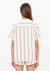 THE UPSIDE women's mocha stripe organic cotton Baja Katia Collared Shirt offers a relaxed fit and features a collar, patch pockets and wooden coconut buttons. Made for lifestyle.