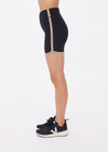 THE UPSIDE women's black recycled rib Rhythm 5inch Spin Short is mid-rise and features cream and mocha binds along side seams. Made for yoga & pilates.