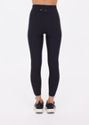 THE UPSIDE women's black recycled rib Rhythm 25inch Legging has a mid-rise fit and features cream and mocha binds along side seams. Made for yoga & pilates.