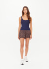 THE UPSIDE women's navy recycled soft peached Amelia Tank Top is designed with a scoop front and back neckline, and features a shelf bra with removeable cups. Made for yoga & pilates.