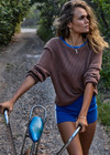 THE UPSIDE women's brown organic cotton Avalon Bayli Knit Crew is a crew neck sweater with drop shoulders in brown, a ribbed neckline in contrast blue and open knit construction. Made for lifestyle.
