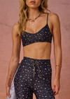 THE UPSIDE women's blue Bellaire Ballet Sports Bra features a cream star print and offers soft support and low coverage, designed with adjustable straps and a supersoft recycled fabrication. Made for yoga & pilates.