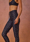 THE UPSIDE women's blue Bellaire 25Inch Legging features a cream star print with a mid rise design, tan striped drawcord and a supersoft recycled fabrication. Made for yoga & pilates.