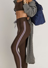 THE UPSIDE women's brown eco tech Oxford 25Inch Legging offers a mid rise with lilac coloured binds down side seams and an elastic drawcord through waist. Made for high impact.