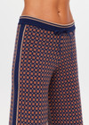 THE UPSIDE women's brown organic cotton Lumiere Juniper Knit Pant is a straight leg pant with a geometric star pattern, a soft elasticated waistband with drawcord and side seam pockets. Made for lifestyle.