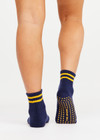 THE UPSIDE women’s navy cotton Salvador Grip Sock is anti slip and has a terry sole with striped yellow midi ankle height. Made for yoga and pilates.
