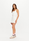 THE UPSIDE women’s cream recycled Kova Racerback Dress has built in shorts with pockets, a scooped front neckline with a racerback bra. Made for tennis.