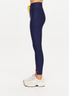 THE UPSIDE women’s navy recycled Eco Tech Salvador 25inch Midi Legging is mid rise and features side seam pockets, a cuffed hem and drawcord waist. Made for yoga and pilates.