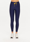 THE UPSIDE women’s navy recycled Eco Tech Salvador 25inch Midi Legging is mid rise and features side seam pockets, a cuffed hem and drawcord waist. Made for yoga and pilates.