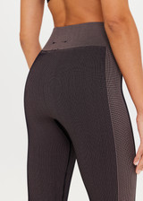 THE UPSIDE Ribbed Seamless 25inch Midi Pant in Mocha is a mid-rise midi length two tone legging with reverse ribbed side panels.