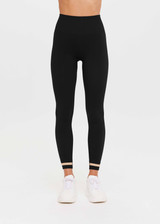 THE UPSIDE Form Seamless 25inch Midi Pant in Black is a solid knitted seamless mid-rise 7/8 length midi pant with contrasting classic sporty strips at cuff.