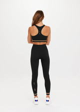 THE UPSIDE Form Seamless 25inch Midi Pant in Black is a solid knitted seamless mid-rise 7/8 length midi pant with contrasting classic sporty strips at cuff.