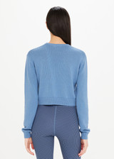 THE UPSIDE The Club Karlie Knit Top in Denim Blue is a sustainable organic cotton knit long sleeve cropped crew with ribbed neckline, hem and cuffs.