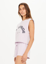 THE UPSIDE Akasha Cropped Muscle in Orchid Purple is a sustainable organic cotton relaxed fit, sleeveless cropped muscle tank printed with our horseshoe logo at centre front.