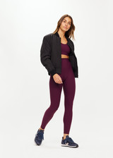 THE UPSIDE Peached 25inch High Midi Pant in Fig Purple is a sustainable 25” midi length legging with a “V” shaped high-rise waistband and printed arrow logo at back waistband.