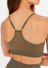 THE UPSIDE Ribbed Seamless Zahra Bra in Khaki is a seamless mid-coverage bra in a two tone seamless khaki rib construction with a T-bar back, adjustable elastic straps and removable cups.