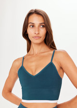 THE UPSIDE Form Seamless Bronte Bra in Pool Blue is a solid knitted seamless mid coverage bra with a longer line fit, a “V” neckline, adjustable straps and removable cups.